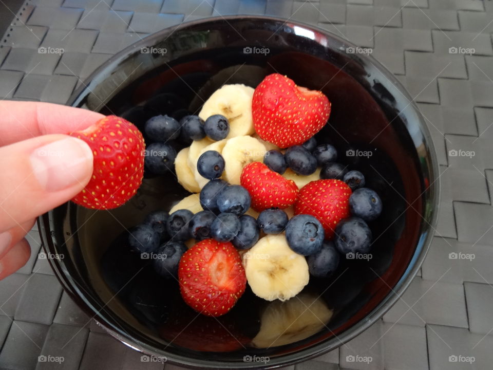 Strawberry, banana and berries for breakfast