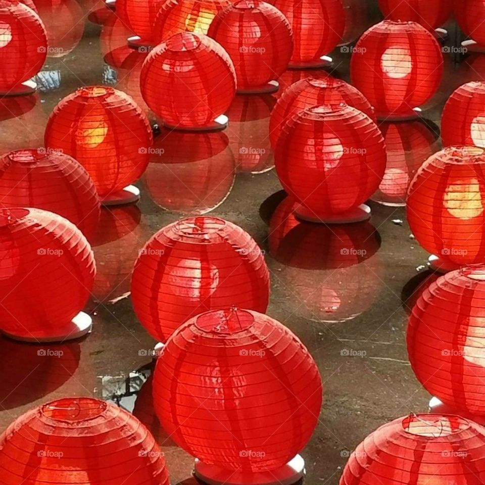 red Chinese lanterns gliding across water