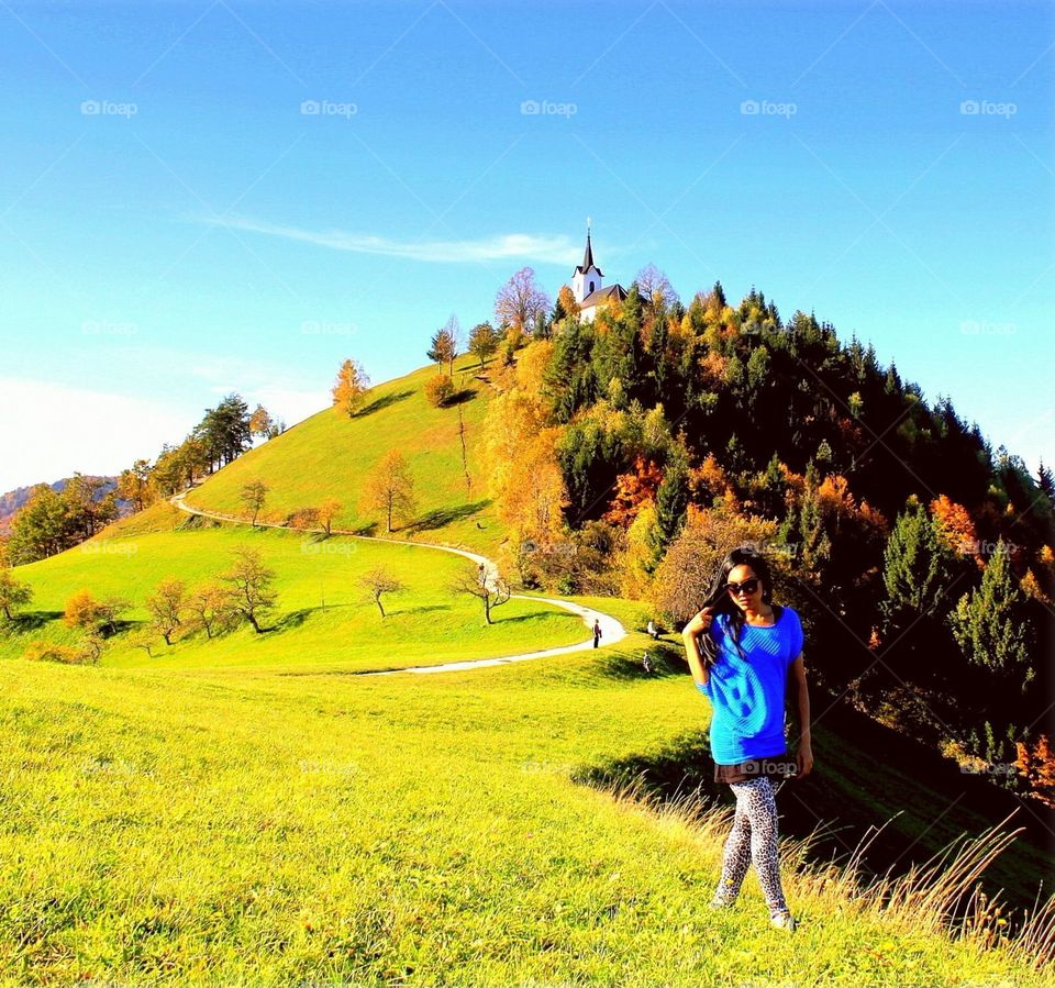 Enjoying autumn colors. Woman enjoying autumn colors on hill