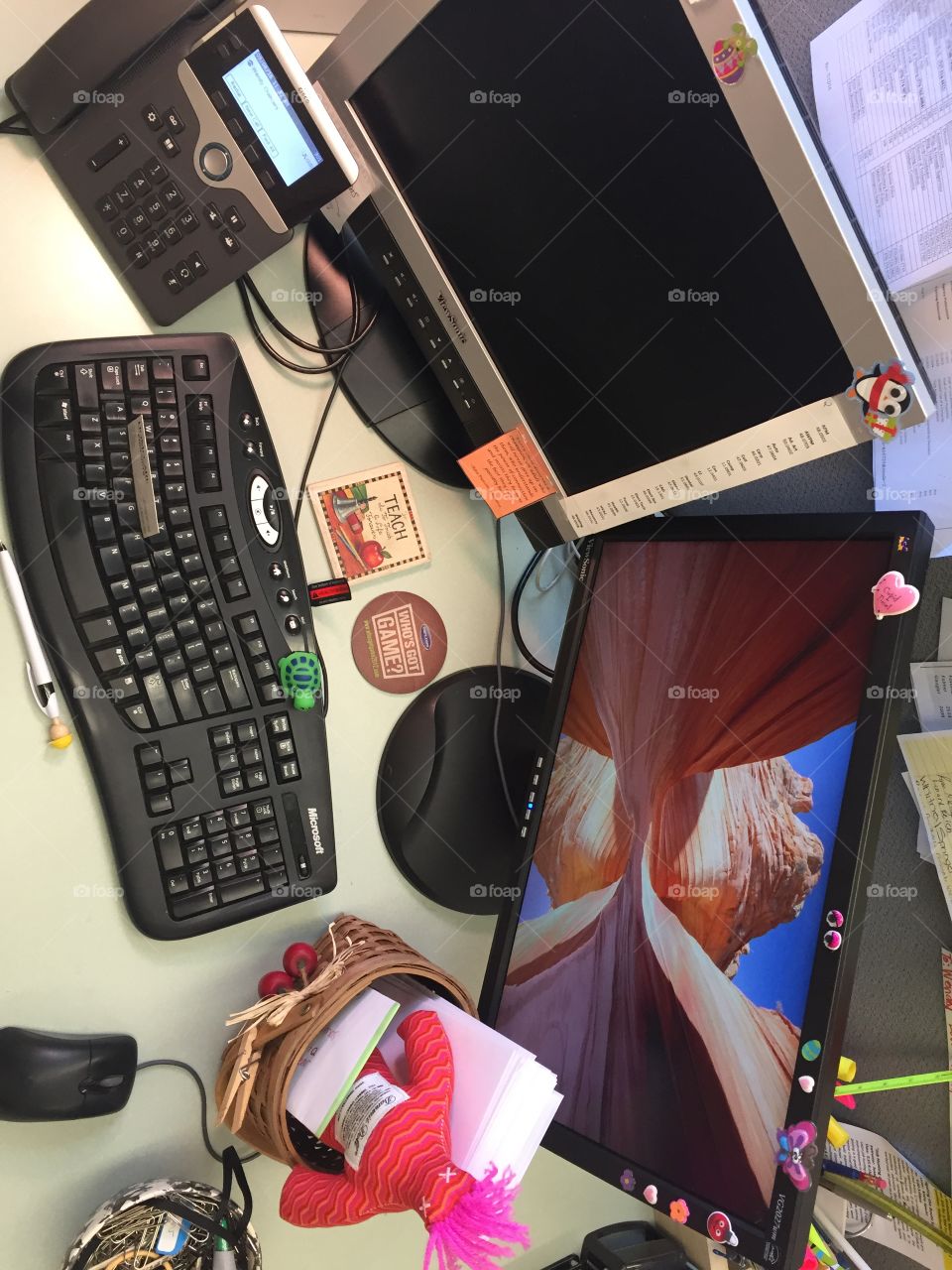 Two monitors to improve efficiency. A damn it doll for a frustrated student (or teacher). A construction man pen to make me smile. Coasters for my drinks. Stickers and doodads that were gifts from students or others.  Because a teachers job is never done!