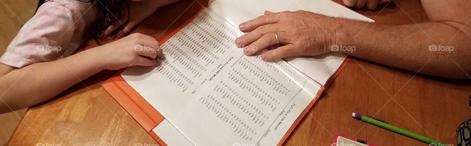 Grandpa and granddaughter working on homework/sightwords