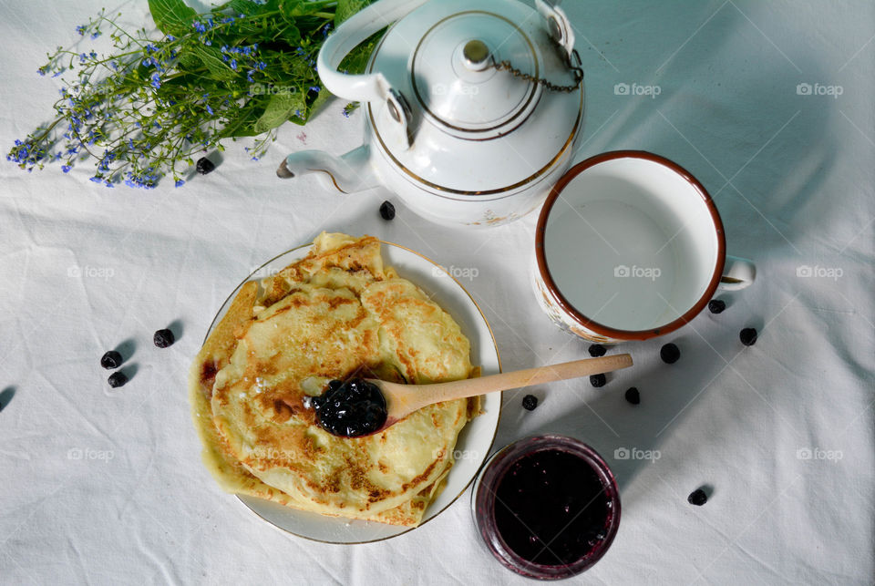 Pancakes, tea and blueberrry jam for breakfast