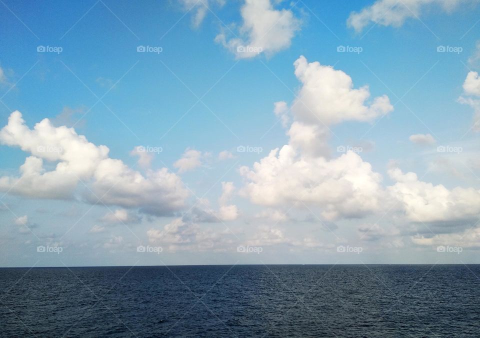 Cloudscape on the sea, the unique pattern of cumulonimbus among the cumulus clouds.