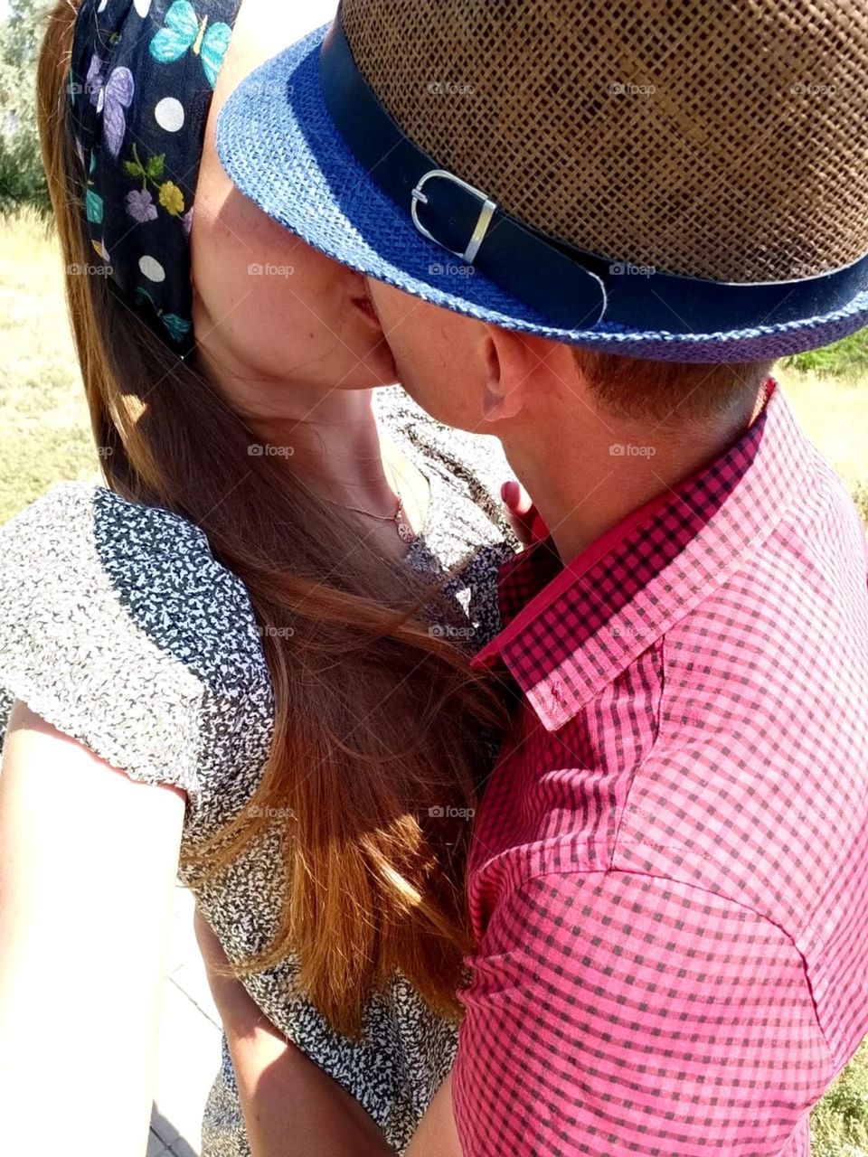 sweet kiss of a married couple in love on a sunny day