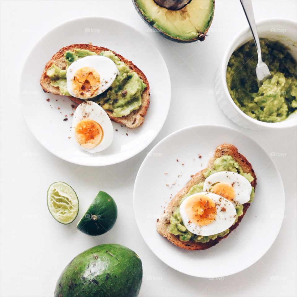 Healthy breakfast with avocado toast with boiled eggs.