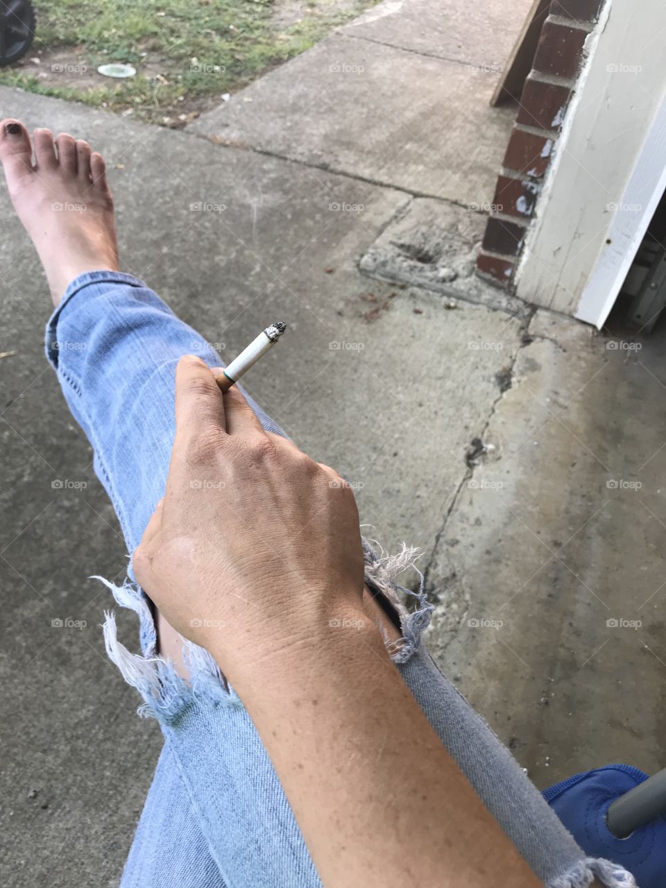 Stubby toes ripped jeans. Smoking kills! Toxic and addiction! Trying to quit a bad habit 