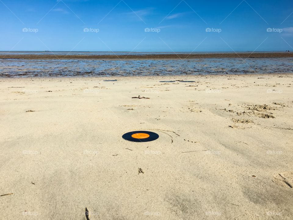 Washed ashore beach scene vinyl 45 record on sandy tropical beach