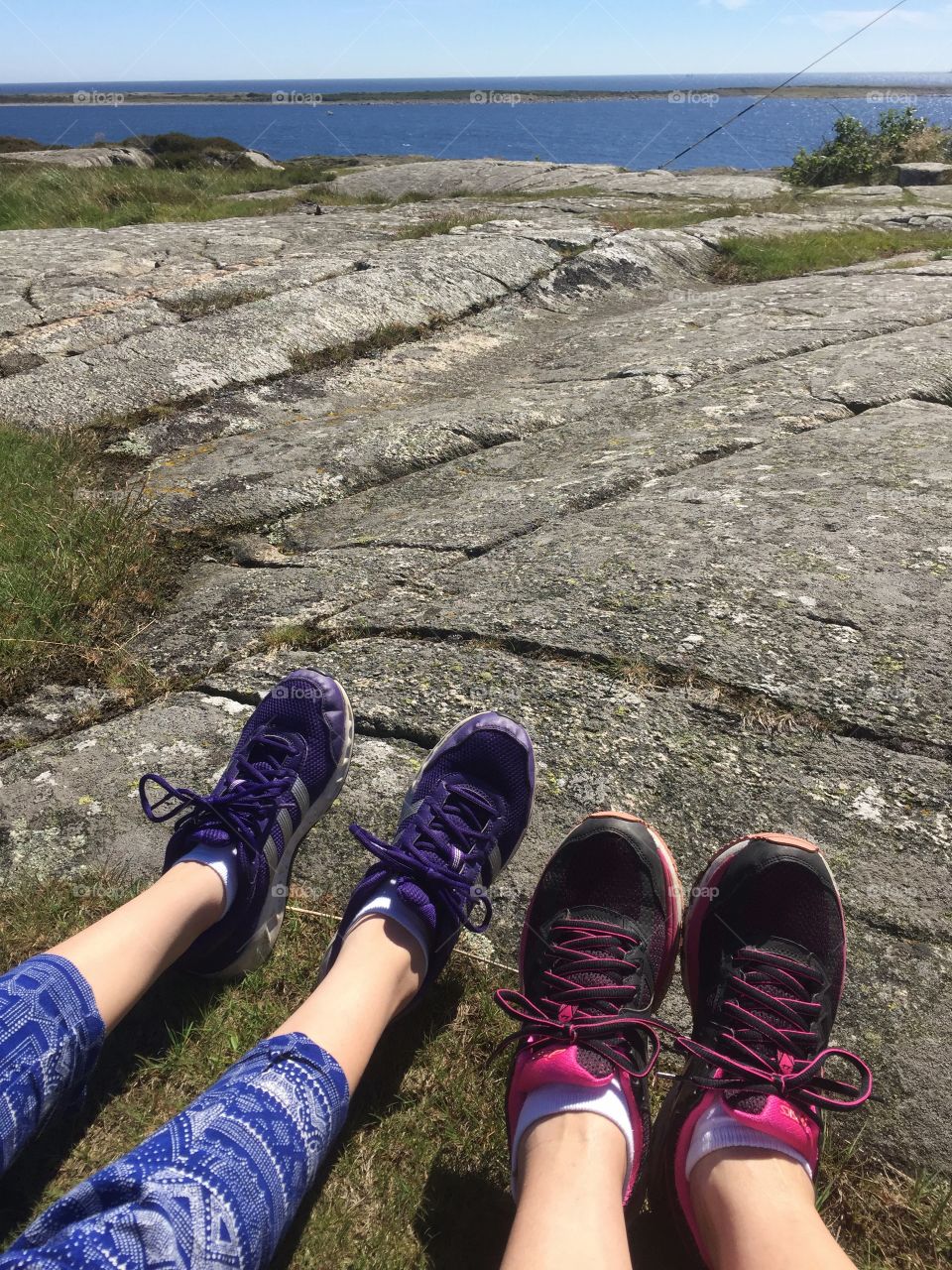 Feet and legs on a cliff