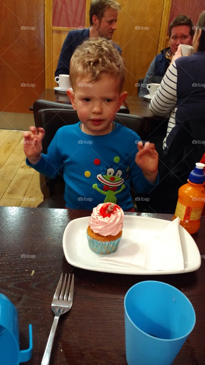 Boy love his cupcake