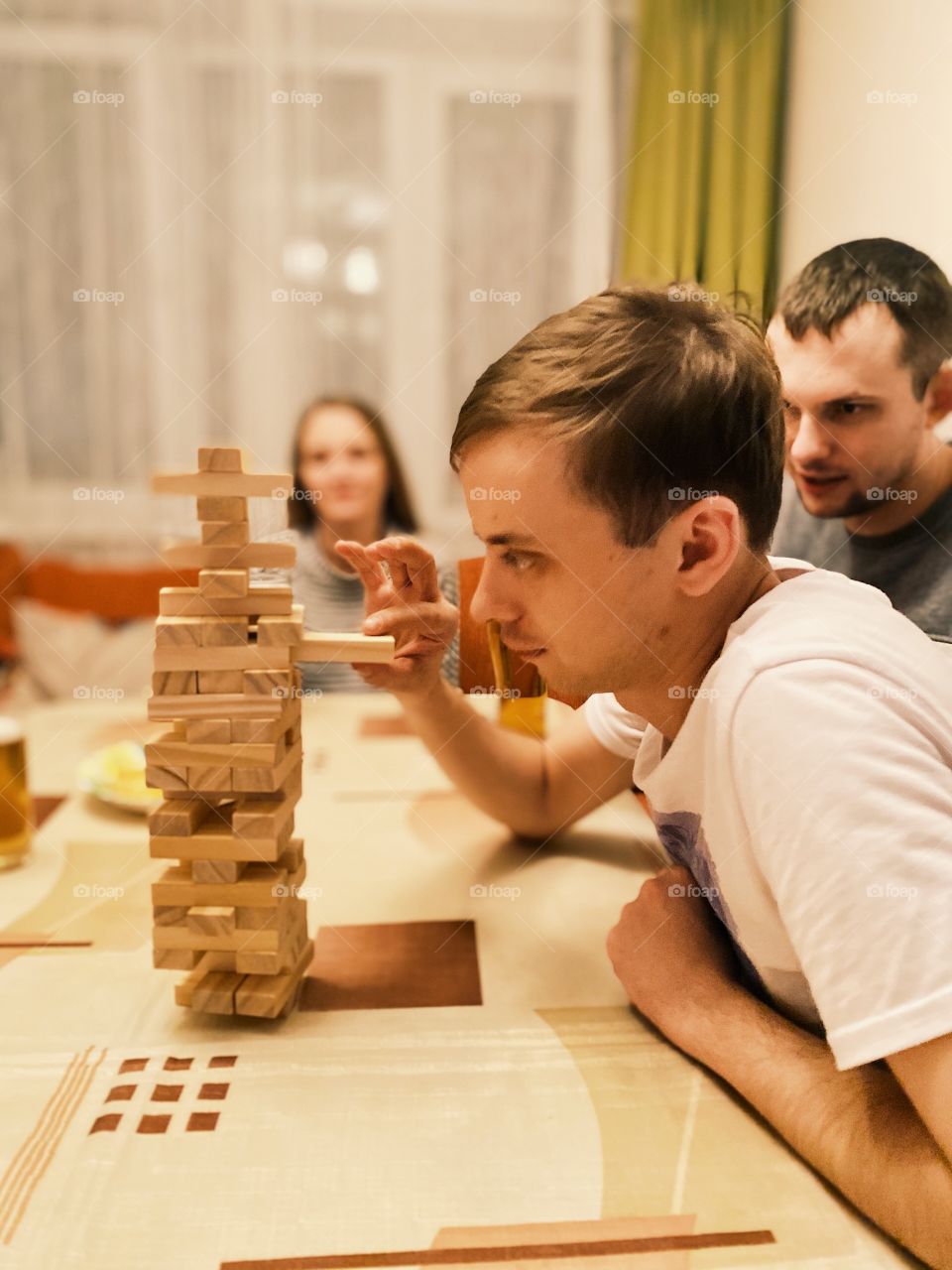 Man playing home game Jenga