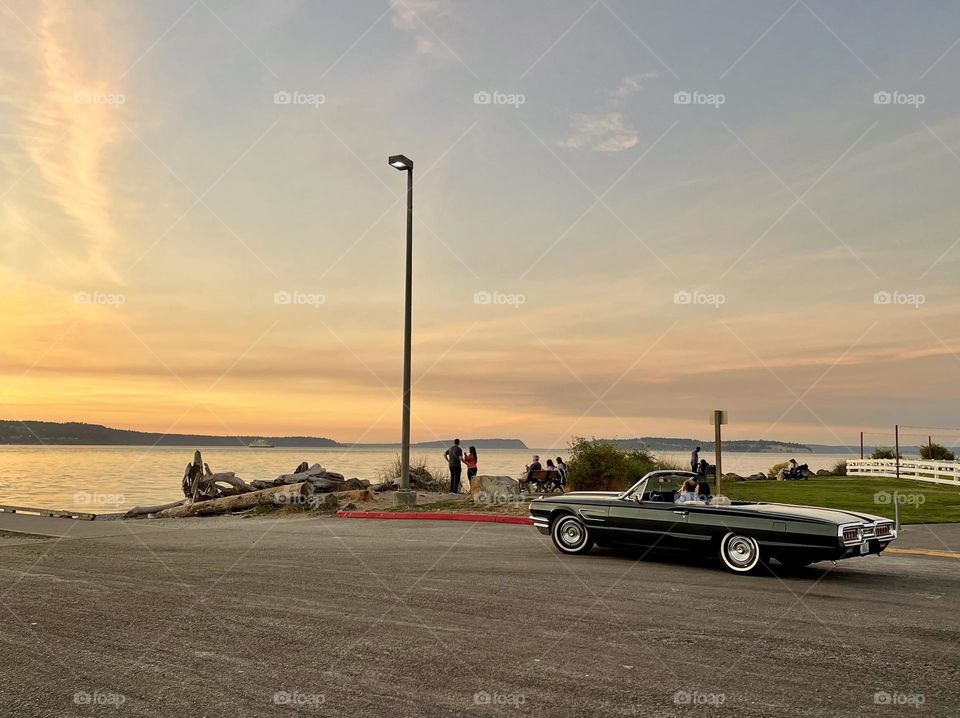 Retro car on the beach with sunset 