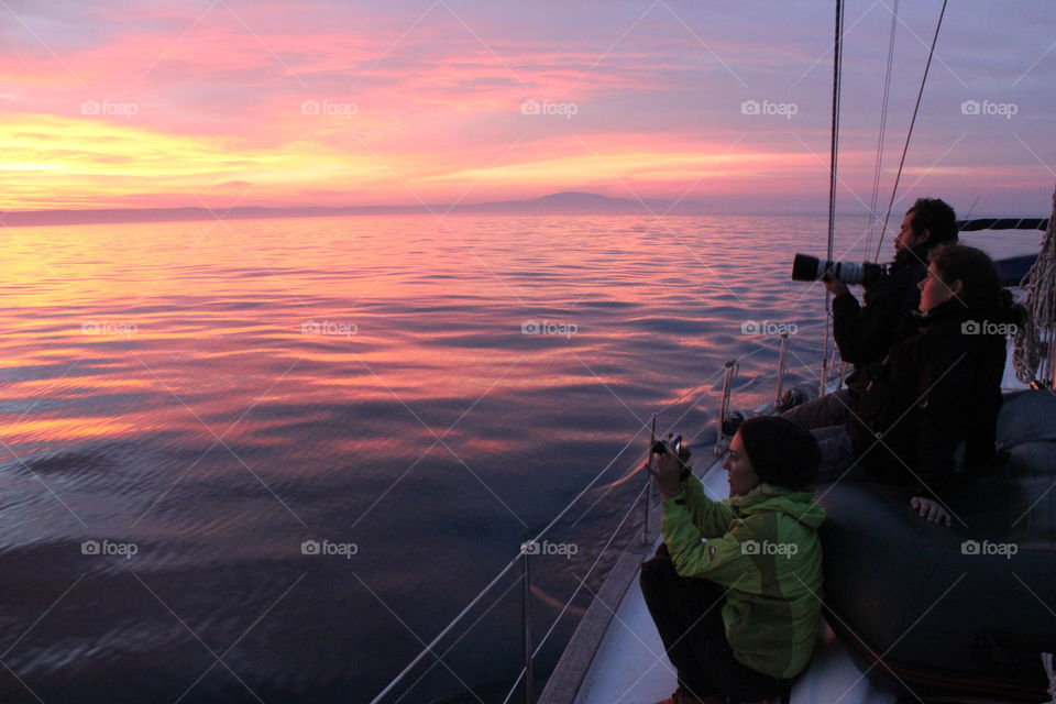 Sailing with the ultimate sunlight. Admiring the astonishing colors of the sea reflecting the sunset.