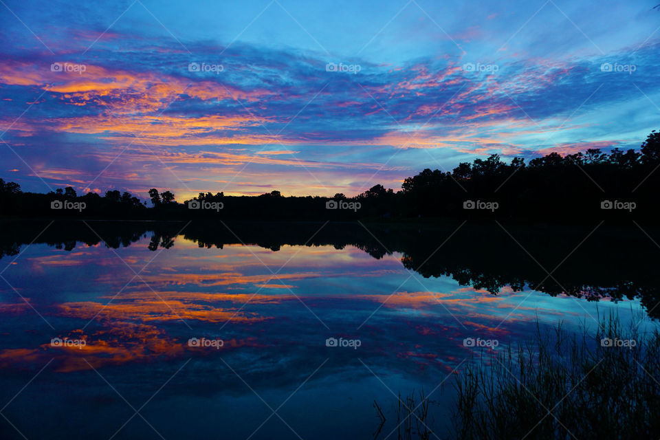 beautiful manycolors sunset reflected in the lake