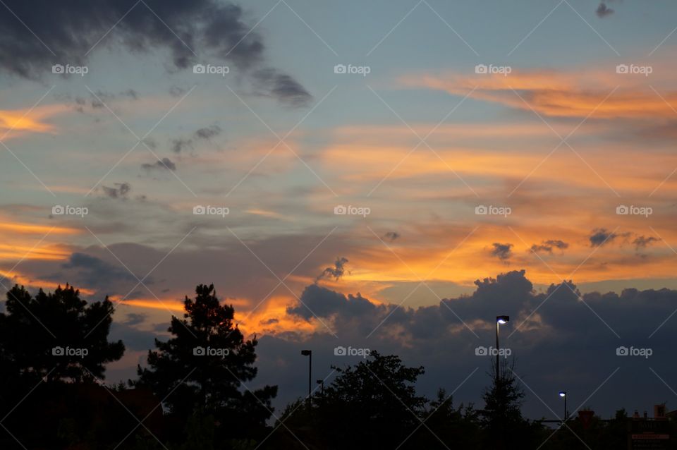 Setting sun lighting up clouds. Photo taken in OK, after rainstorm.  Sunset lights of clouds with color.