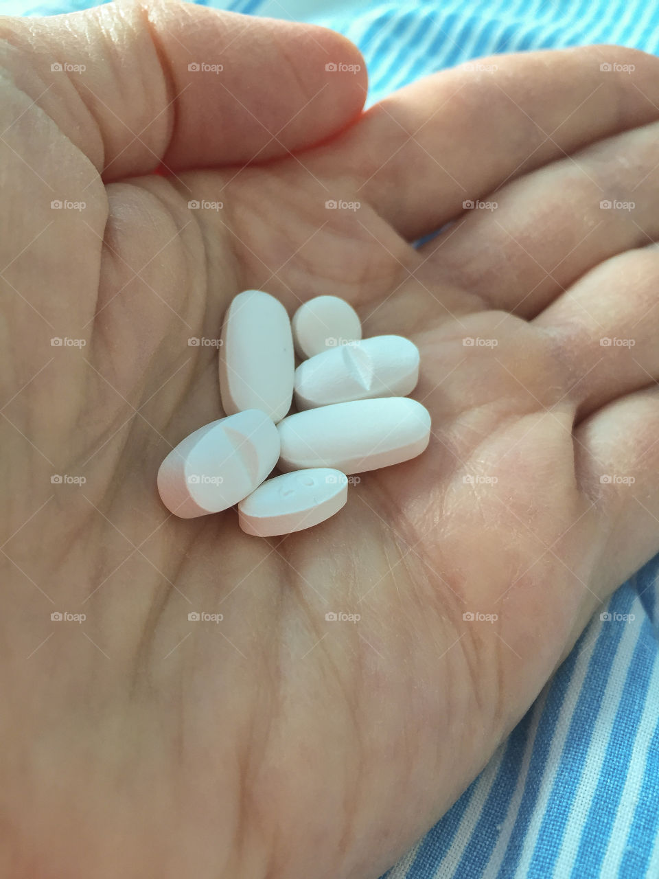 Close up of a womens hand holding a dose of medicine at a hospital in Sweden.