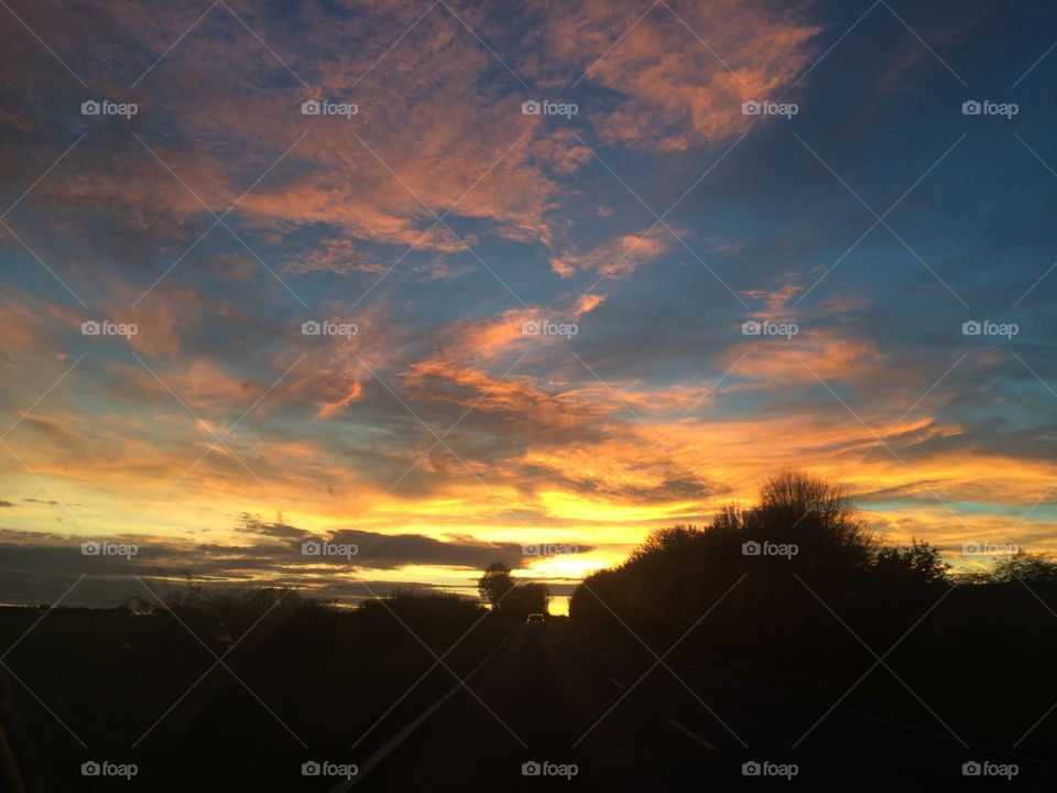 Beautiful sunset sky pink yellow clouds silhouette 