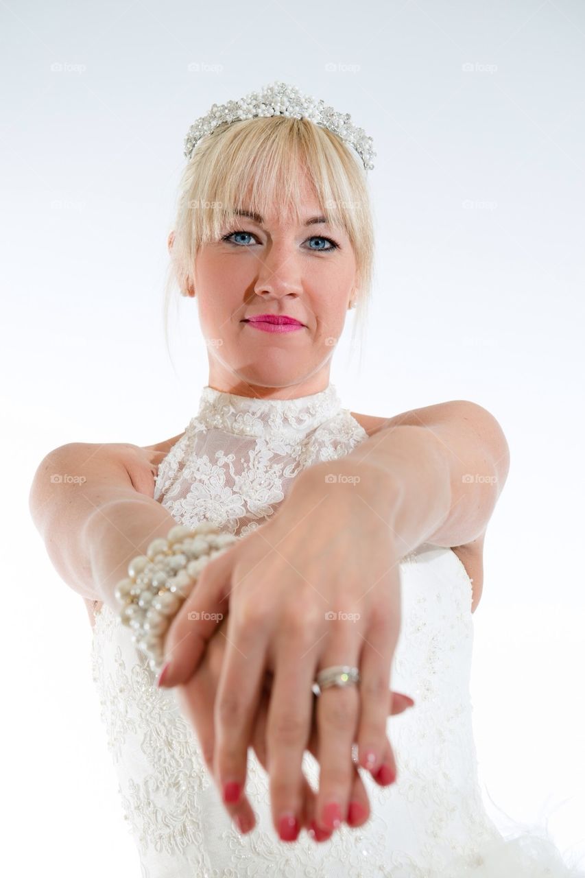 Smiling bride shows wedding ring upright
