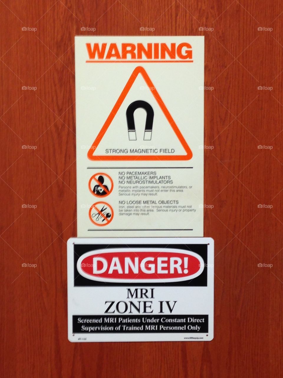 Warning signs on the outside door to the MRI room at hospital