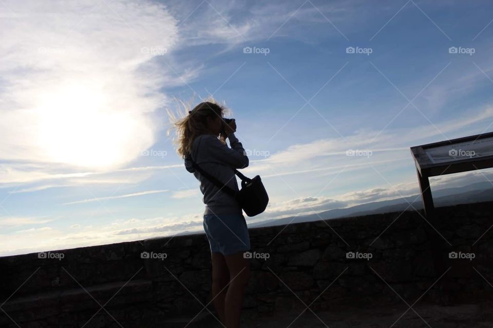 Girl shooting photo at dawn 