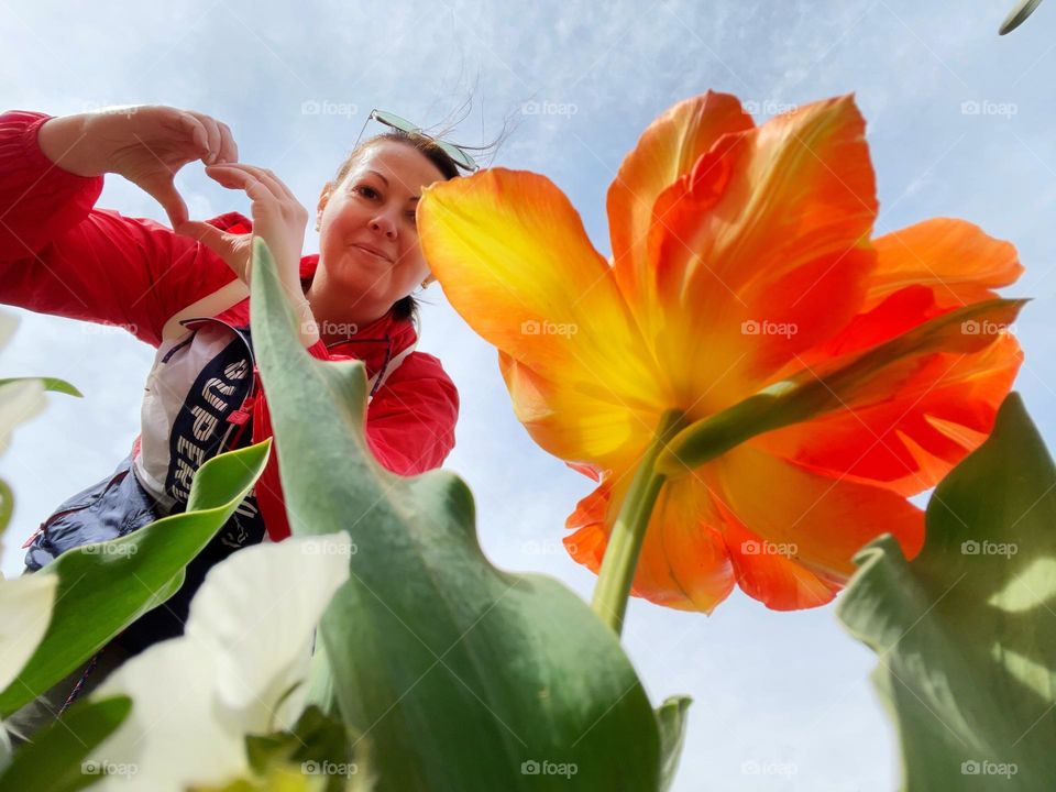 Selfie with a big spring tulip flower