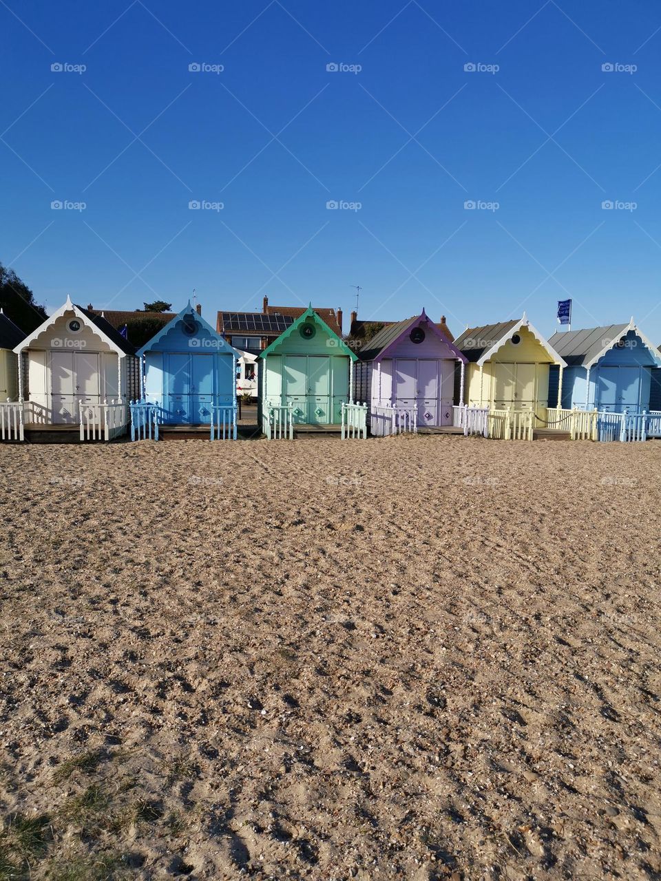 Summer in UK. Colourful beach houses. Sunny day.