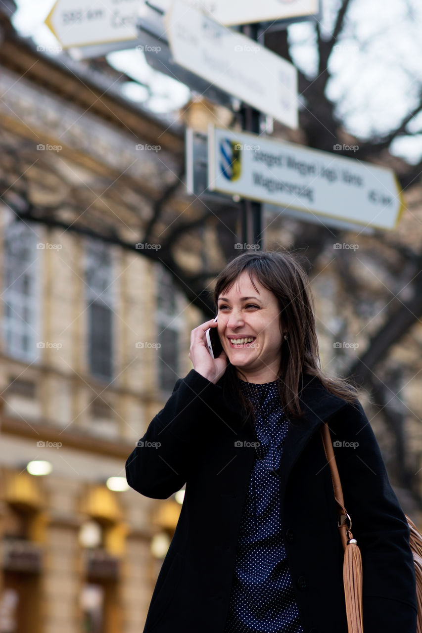 Happy woman speaking on mobile phone