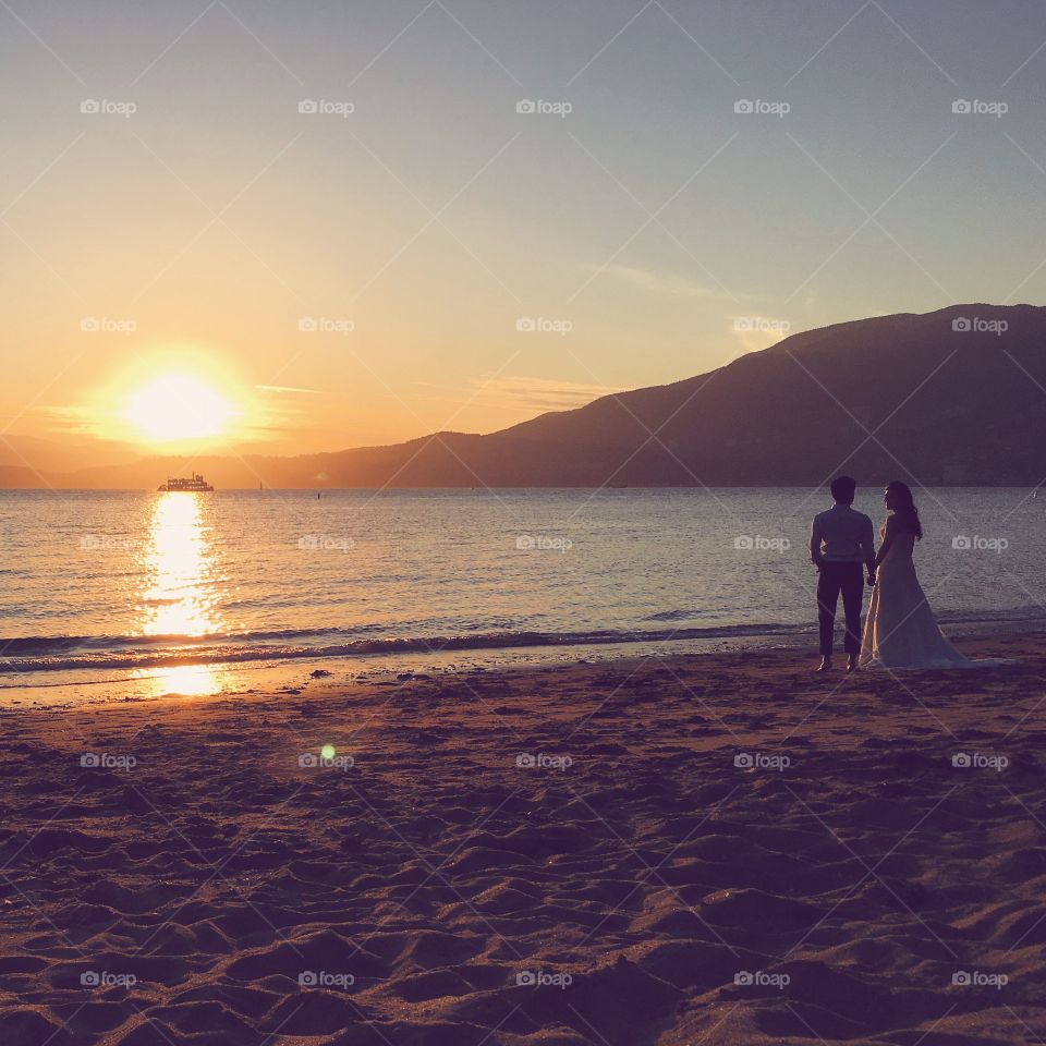 Romantic wedding couple on the beach at sunset