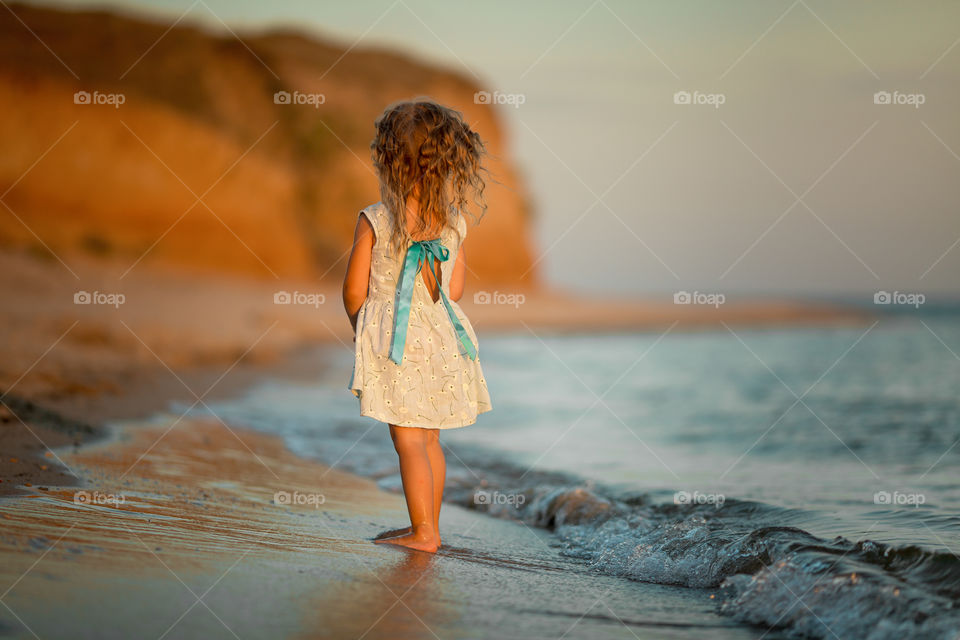 Little girl near sea 