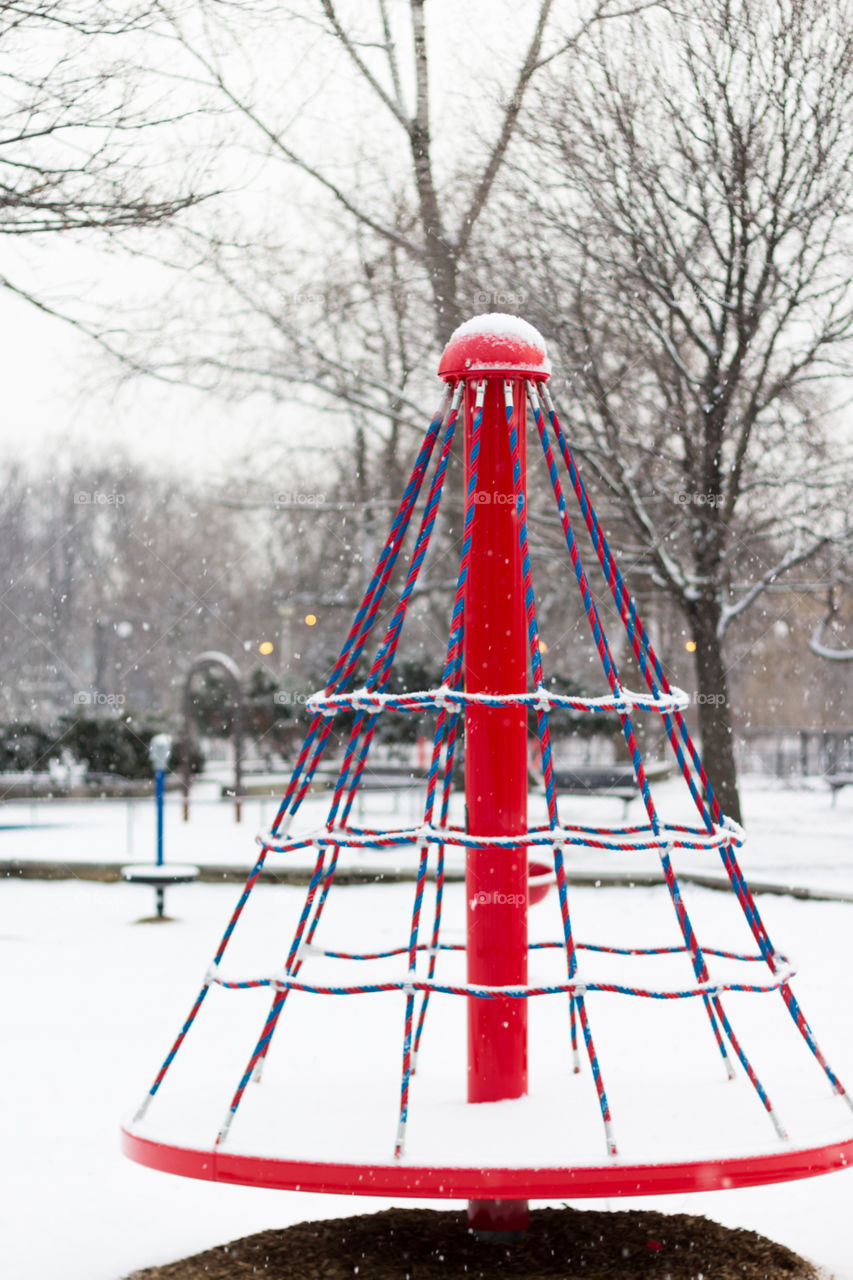 The empty playground in the snow