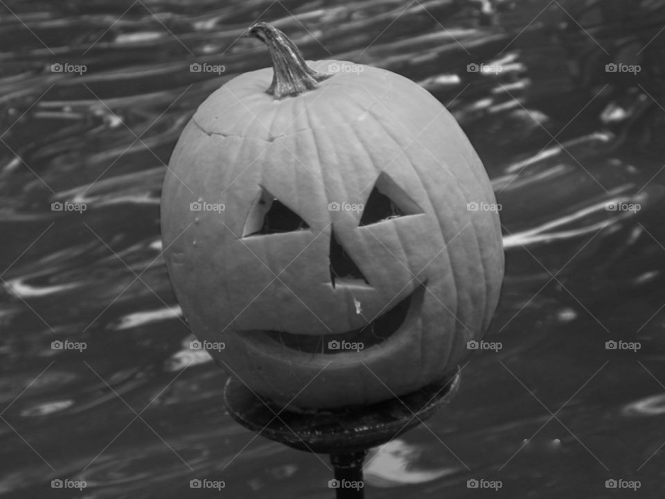 Pumpkin on metal over water done in black and white