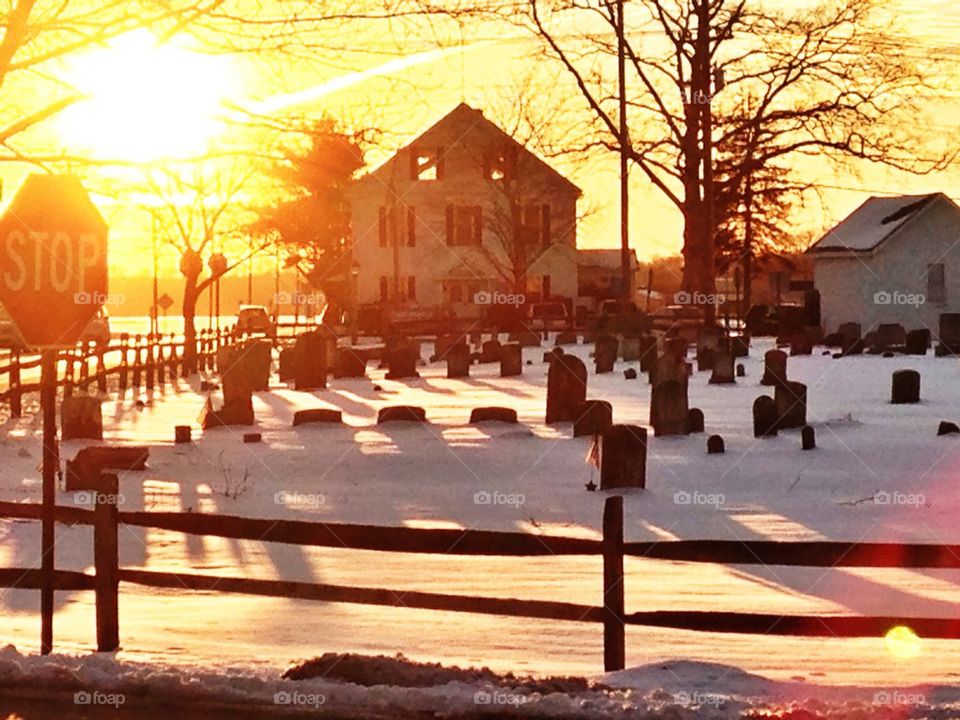 House and graveyard at sunset