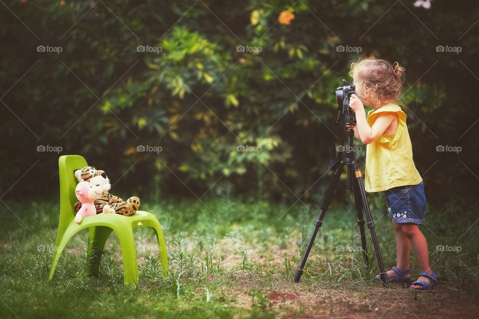 Little girl makes photos to her toys