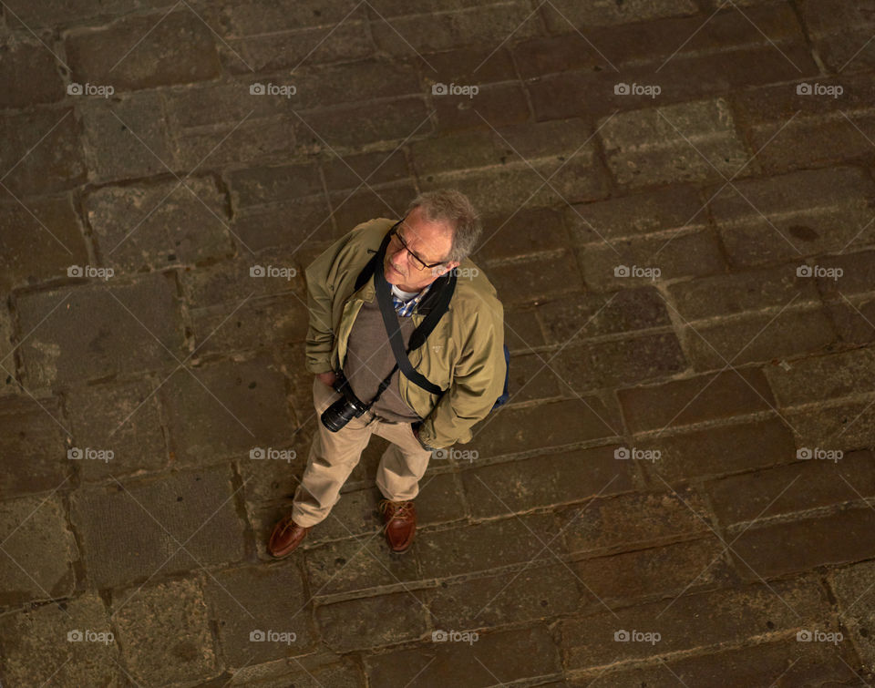 High angle view of photographer man standing on sidewalk
