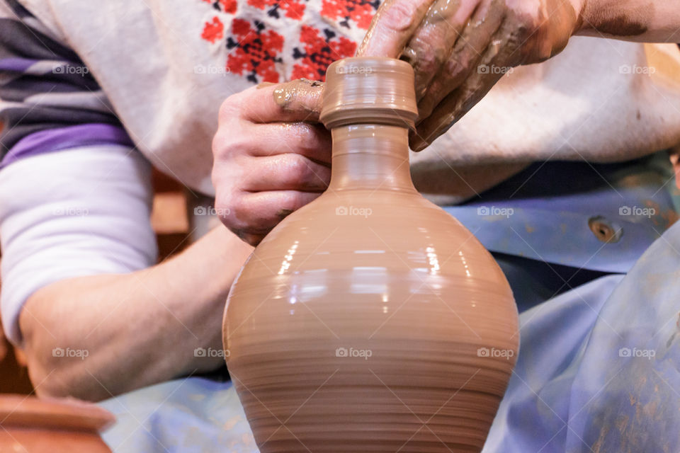 Close-up of person making pottery