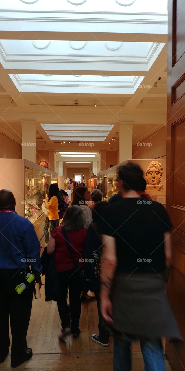 room in museum with people looking at exhibits