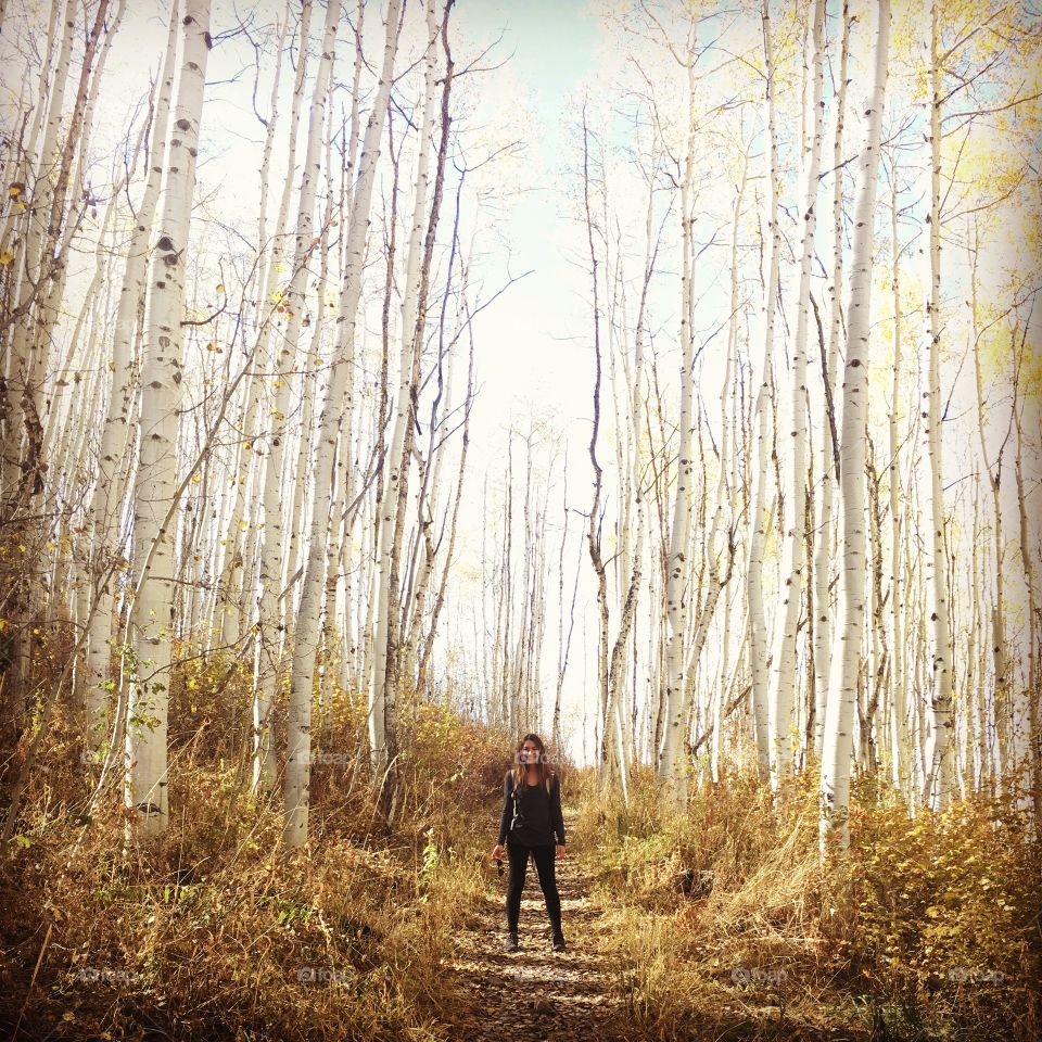 Smiling young woman in the woods