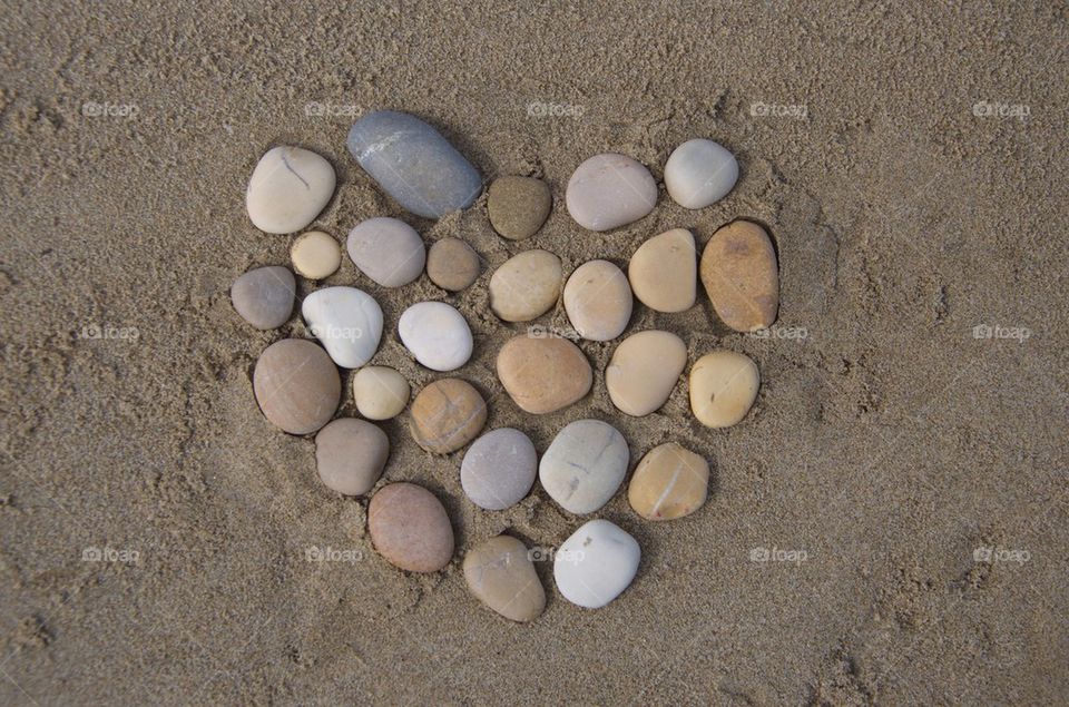 Hearth, pebbles composition on the sand