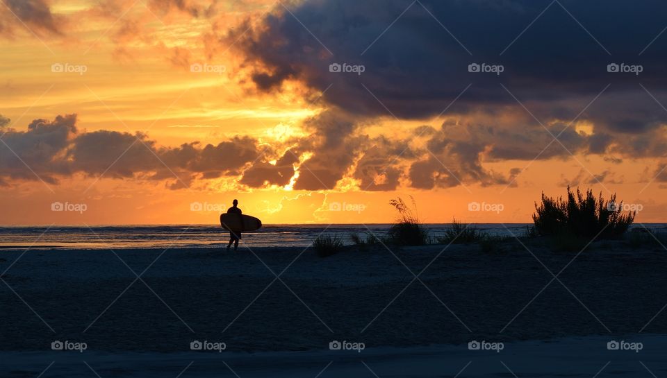Surfer at sunrise
