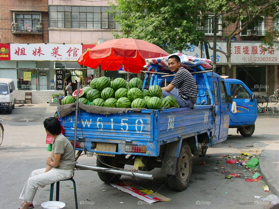 Chinese man selling watermelons