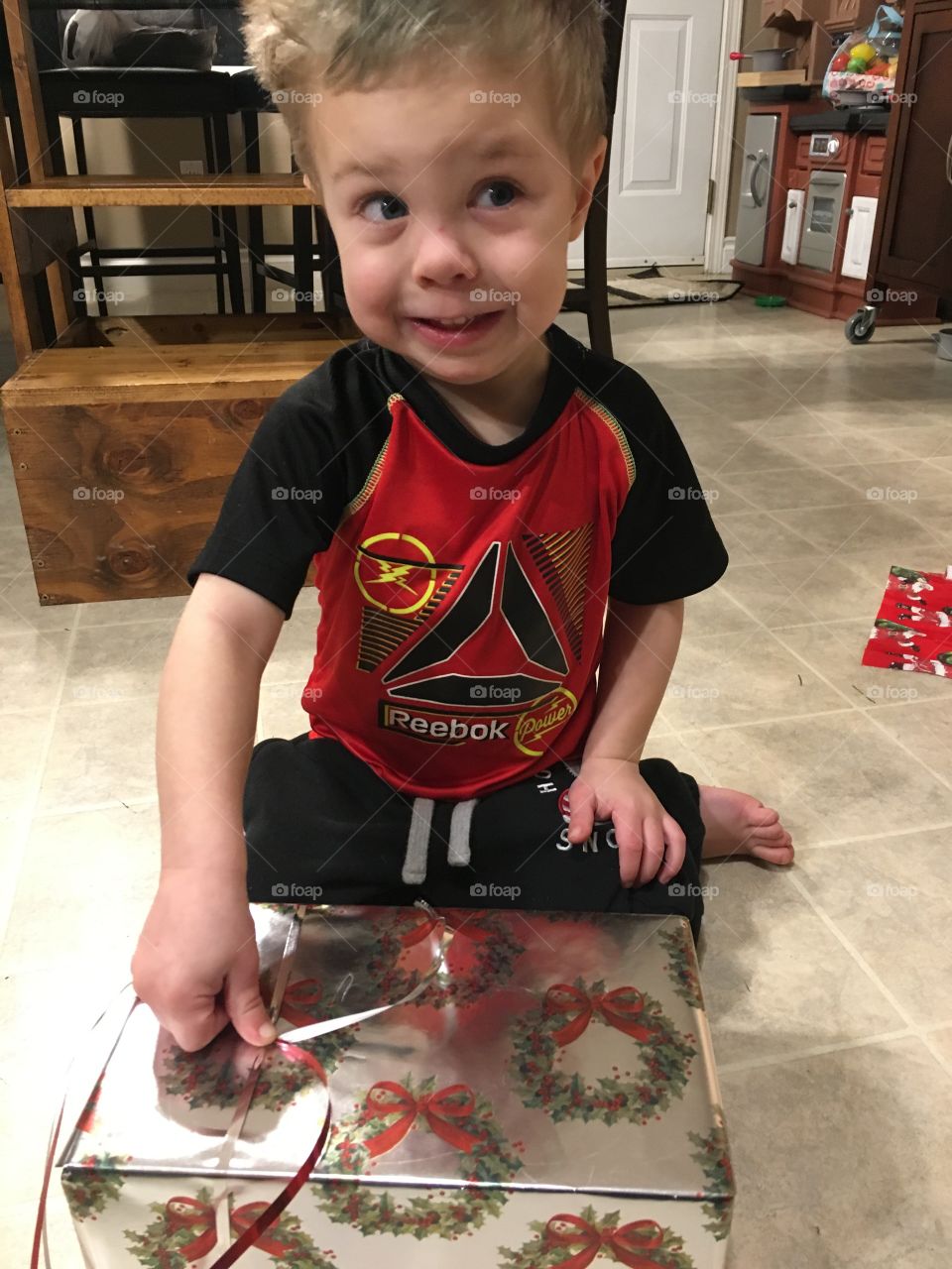 A toddler helping with ribbon