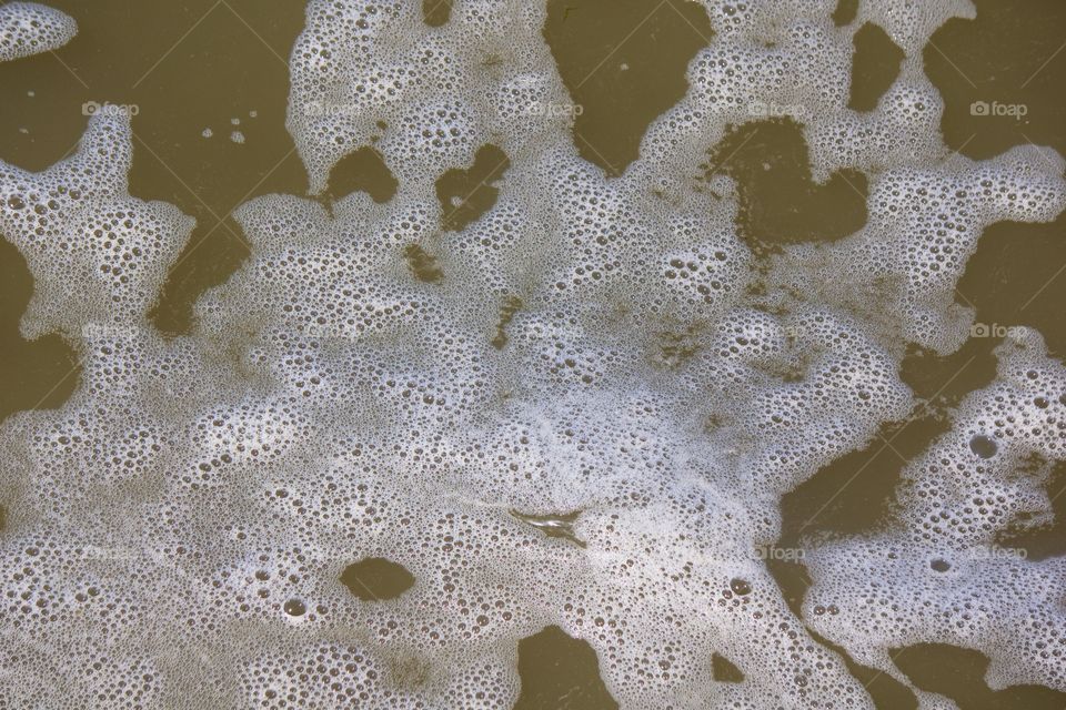 Bird's eye closeup of air bubbles in the polluted Hudson River, Manhattan, New York City, 