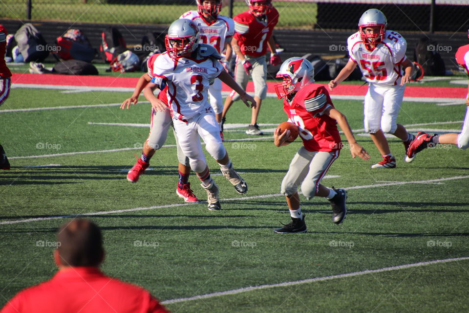 Boys playing in football game