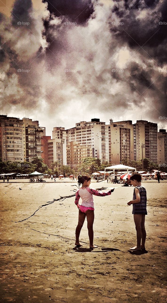 Children play with kite on the beach