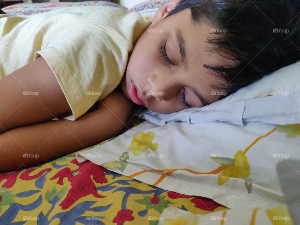 small boy taking afternoon nap at home