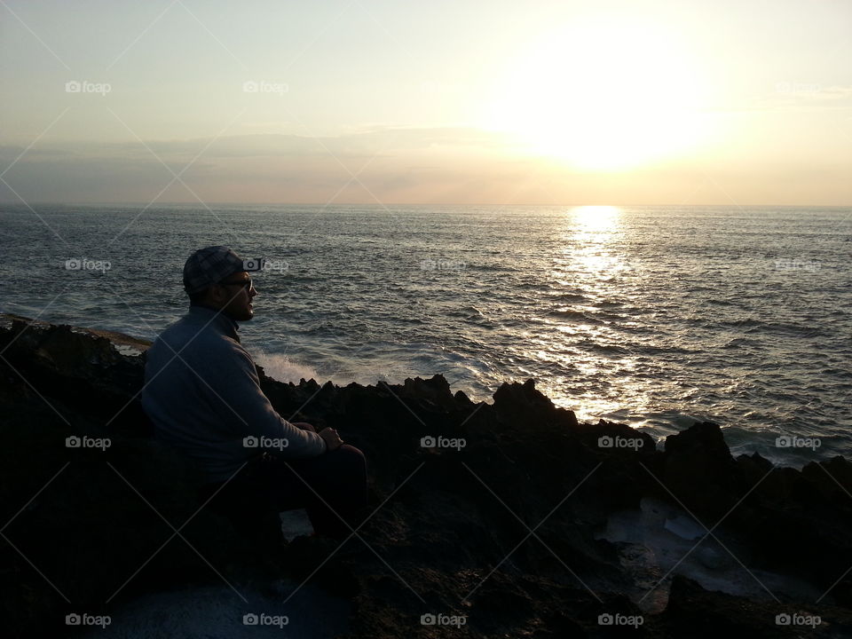 Man sitting near sea side