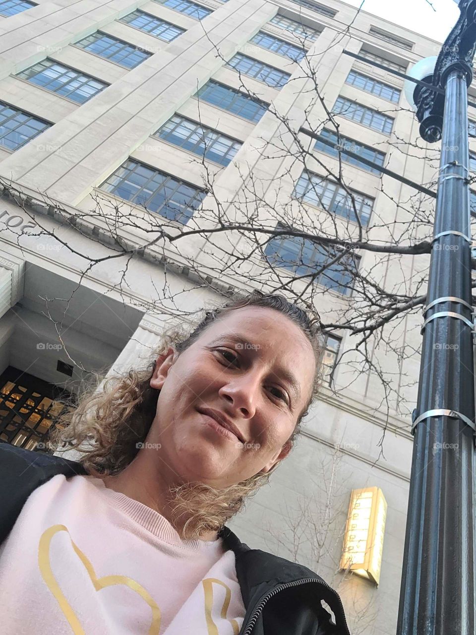 Young Woman in Front of a Tall Building