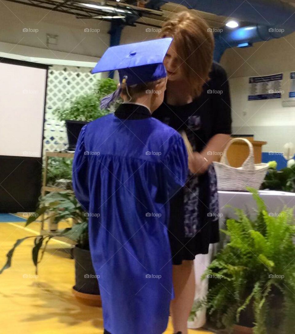 Woman talking with a student wearing gown