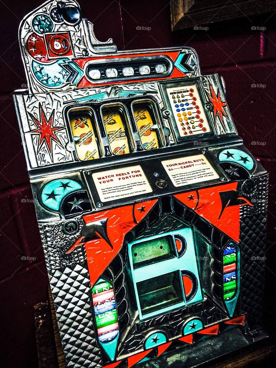 Vintage real reel slot machine. This one armed bandit is a classic. Heavy metal, shiny, chrome designed to break your heart and separate you from all your hard earned money money. Luck has nothing to do with it!