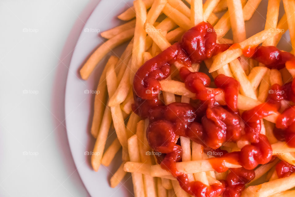 French Fries Potatoes With Red Sauce On Plate
