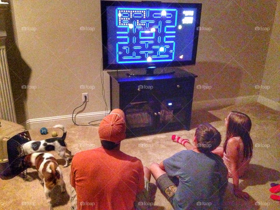 Pac-man old school style. Dad and kids playing old pac-man game